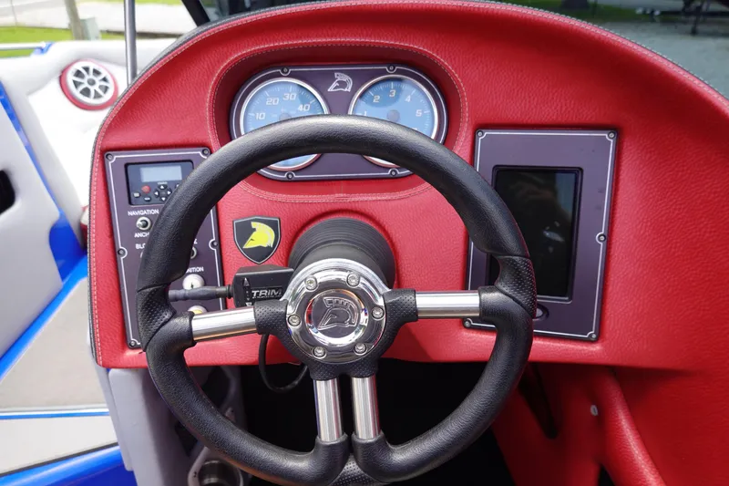 Slide: The Image of Steering wheel and dashboard of 2013 Centurion Enzo SV244 boat, featuring red leather trim. - 12