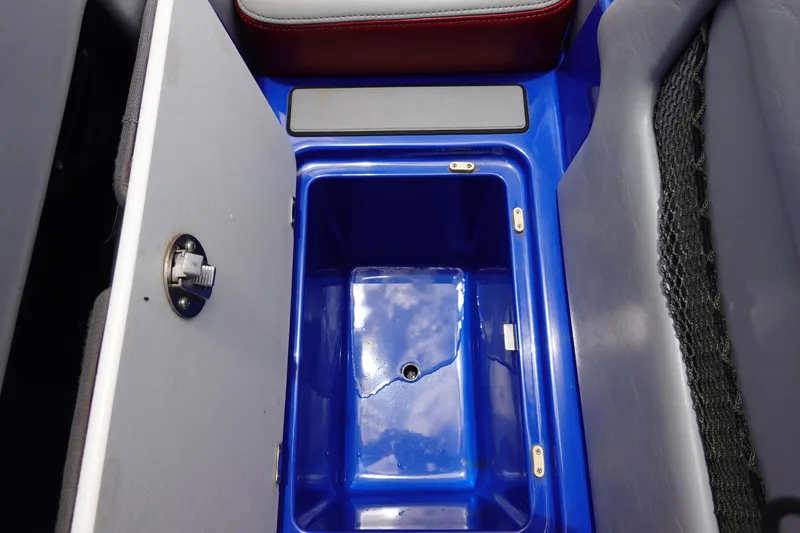 Slide: The Image of Open storage compartment in 2013 Centurion Enzo SV244 boat, featuring blue interior. - 18