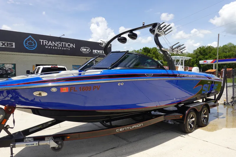 Slide: The Image of 2013 Centurion Enzo SV244 boat in blue, parked at Transition Watersports. - 2