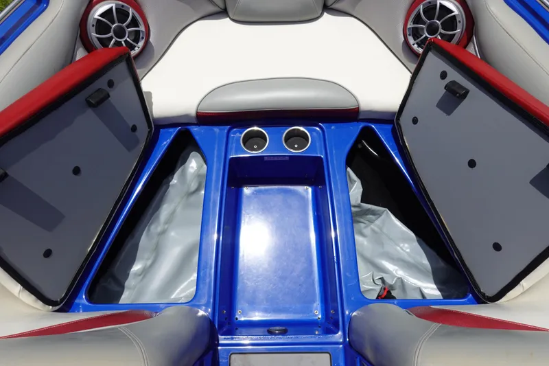 Slide: The Image of Interior of 2013 Centurion Enzo SV244 boat with open storage compartments and speakers. - 20