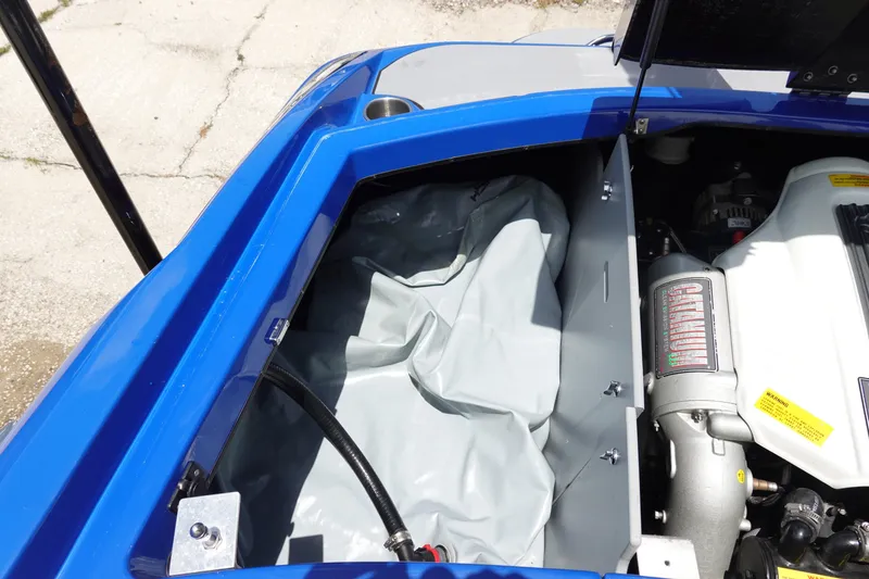 Slide: The Image of Engine compartment of a 2013 Centurion Enzo SV244 boat, featuring a blue exterior. - 23