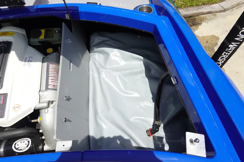 Slide: The Image of Engine compartment of a 2013 Centurion Enzo SV244 boat, featuring a blue exterior. - 24