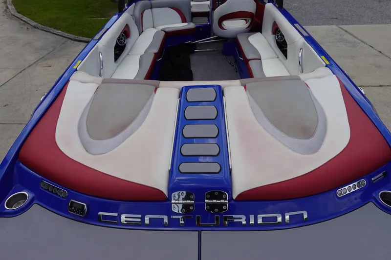 Slide: The Image of 2013 Centurion Enzo SV244 boat interior with red and white seating, blue accents. - 6