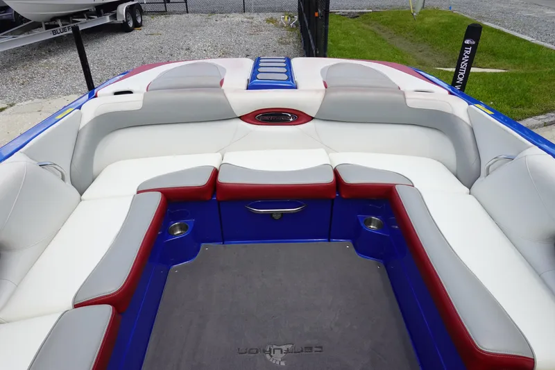 Slide: The Image of 2013 Centurion Enzo SV244 boat interior with white, red, and blue seating. - 8