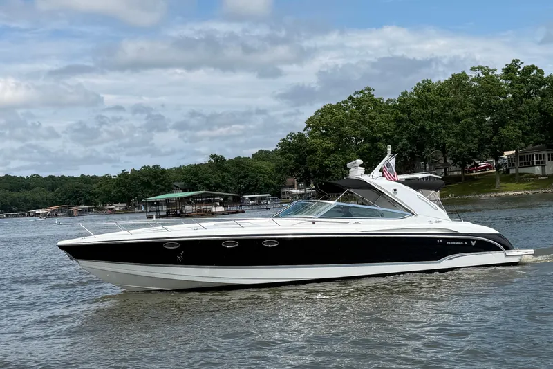 Slide: The Image of 2006 Formula 400 Super Sport boat cruising on a lake with trees in the background. - 1