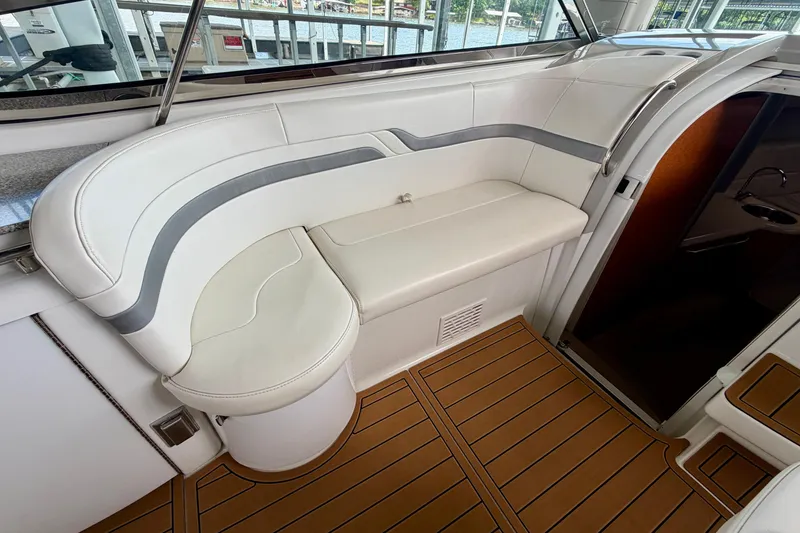 Slide: The Image of Interior seating of 2006 Formula 400 Super Sport boat with white upholstery and wood flooring. - 14