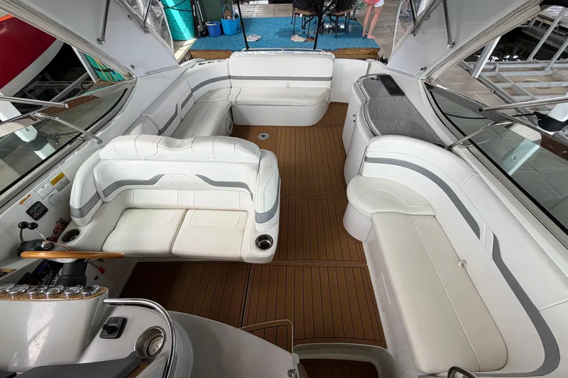 Slide: The Image of Interior of a 2006 Formula 400 Super Sport boat with white seating and wood flooring. - 16