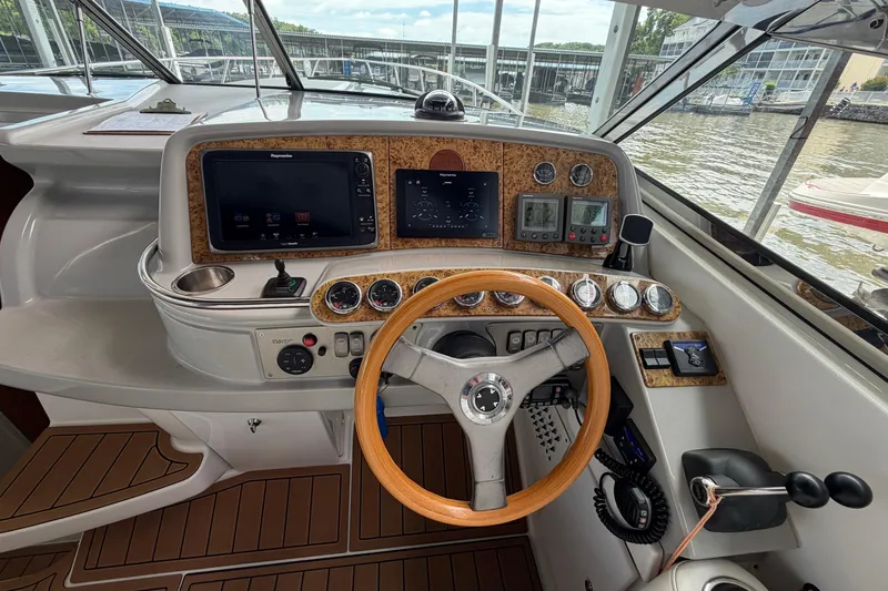 Slide: The Image of 2006 Formula 400 Super Sport boat cockpit with wooden steering wheel and modern navigation instruments. - 17