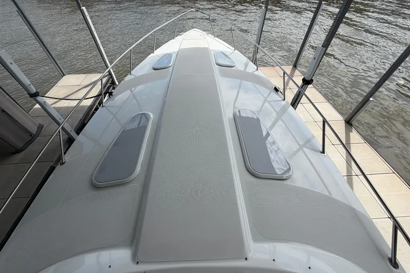 Slide: The Image of 2006 Formula 400 Super Sport boat docked, showcasing sleek deck design and water backdrop. - 22
