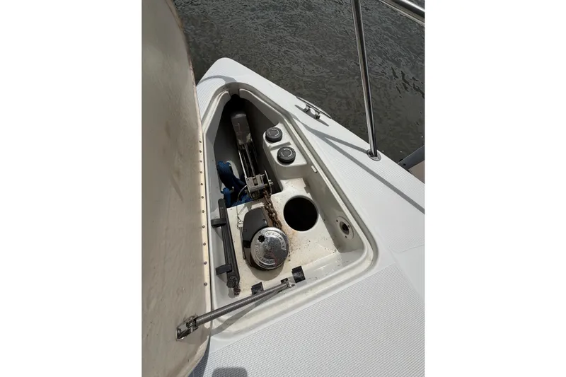 Slide: The Image of Open anchor compartment on 2006 Formula 400 Super Sport boat, showing chain and winch. - 23
