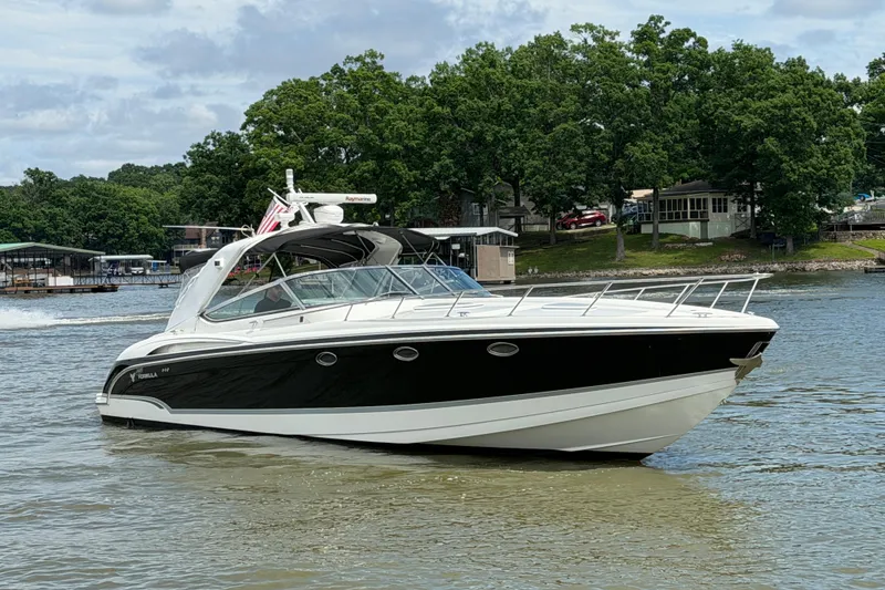 Slide: The Image of 2006 Formula 400 Super Sport boat cruising on a lake with lush green shoreline. - 3