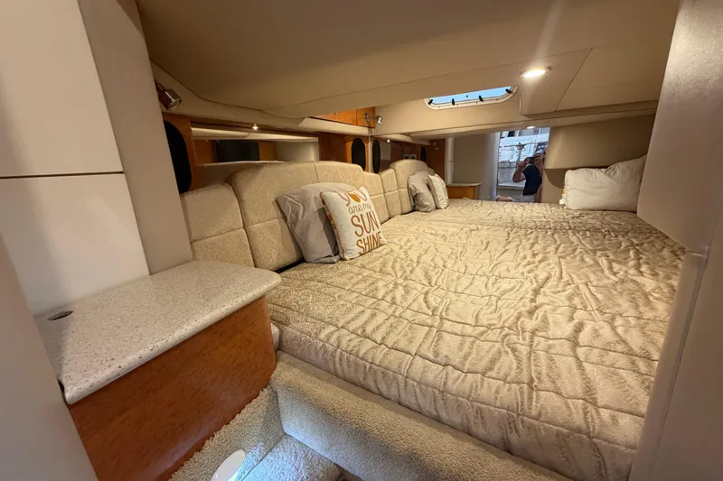 Slide: The Image of Interior cabin of a 2006 Formula 400 Super Sport boat, featuring a cozy bed. - 41