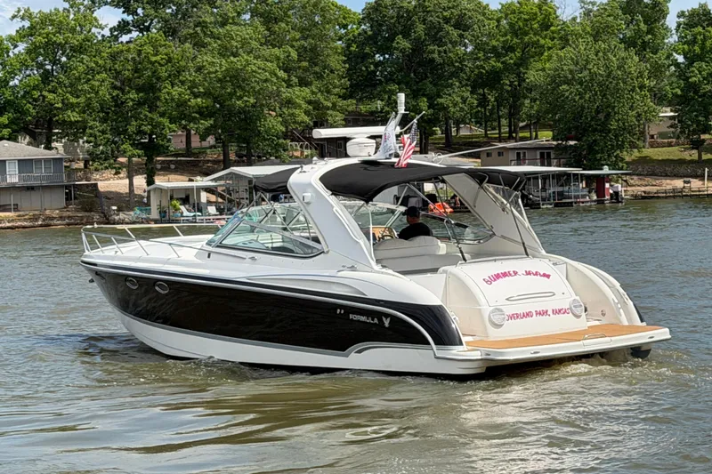 Slide: The Image of 2006 Formula 400 Super Sport boat cruising on a lake with trees in the background. - 5