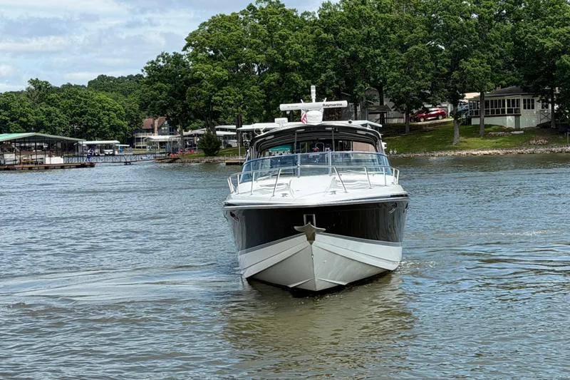 Slide: The Image of 2006 Formula 400 Super Sport boat cruising on a lake with trees in the background. - 6