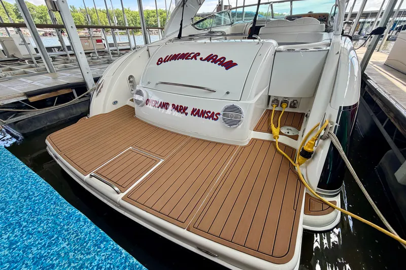 Slide: The Image of 2006 Formula 400 Super Sport boat docked, featuring teak deck and electrical connections. - 7