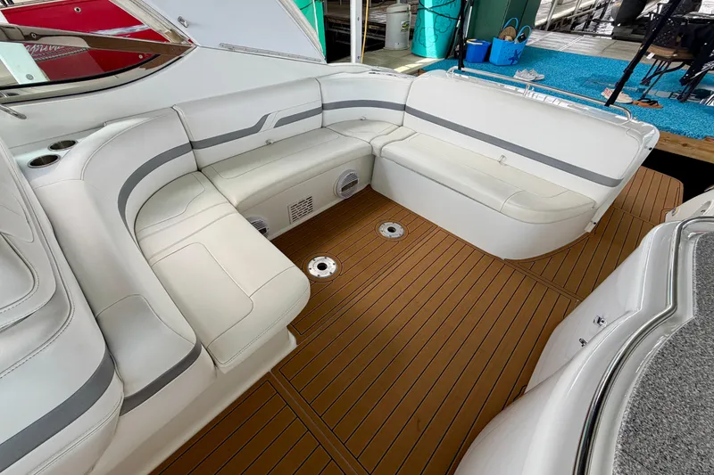Slide: The Image of 2006 Formula 400 Super Sport boat interior with white seating and teak flooring. - 9