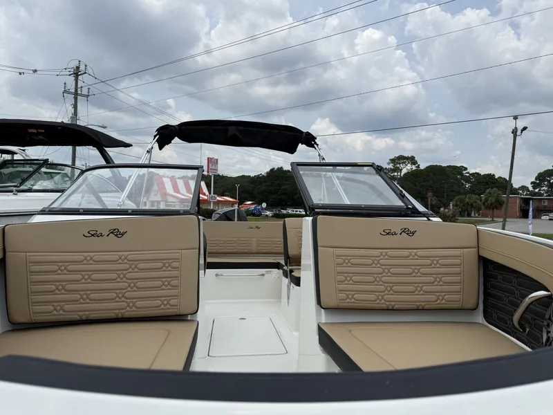 Slide: The Image of The image shows the cockpit of a Sea Ray SPX 210 Outboard with beige upholstery and clear windshields. - 14