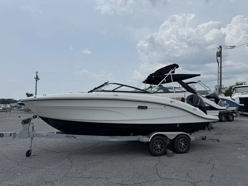 Slide: The Image of A 2026 Sea Ray SPX 210 Outboard sits on a trailer in a parking lot. - 3