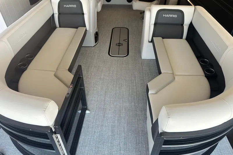 Slide: The Image of 2026 Harris Cruiser 230 SLDH interior with plush seating and cup holders. - 2
