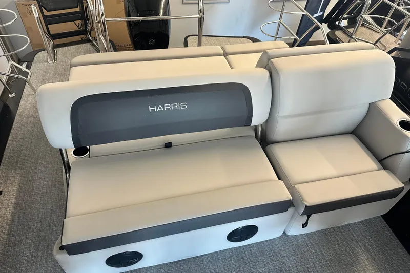 Slide: The Image of 2026 Harris Cruiser 230 SLDH boat interior with plush seating and cup holders. - 4