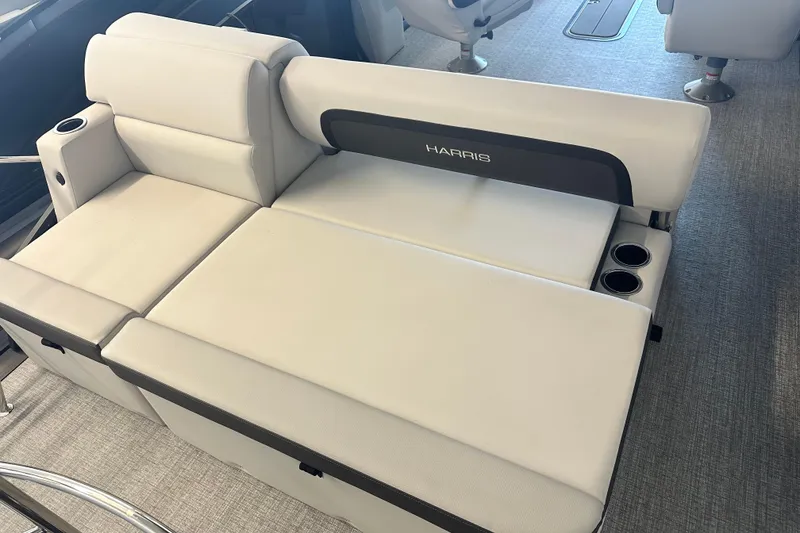 Slide: The Image of 2026 Harris Cruiser 230 SLDH boat interior with plush seating and cup holders. - 5