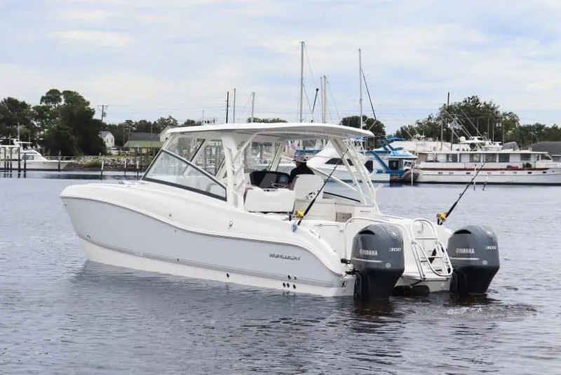 Slide: The Image of Manufacturer Provided Image: 2026 World Cat 325 DC boat with dual Yamaha engines on calm water. - 2