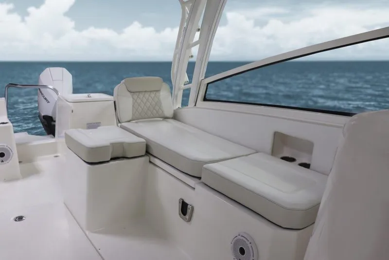 Slide: The Image of Manufacturer Provided Image: 2026 World Cat 325 DC boat interior with cushioned seating, ocean view in background. - 9