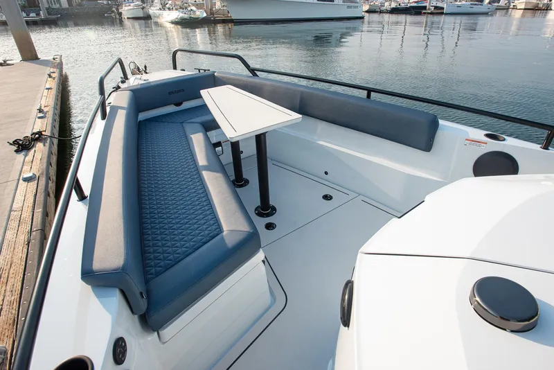 Slide: The Image of 2023 BRABUS Shadow 500 T-Top AFT Cabin with sleek seating and table on deck. - 19