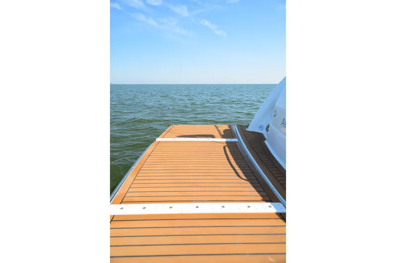 Slide: The Image of 2010 Formula 45 Yacht deck overlooking calm ocean under clear blue sky. - 13