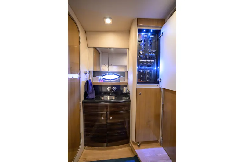 Slide: The Image of Interior of 2010 Formula 45 Yacht featuring a compact bathroom with sink and control panel. - 19