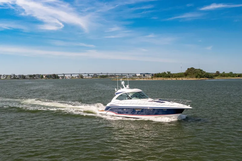 Slide: The Image of 2010 Formula 45 Yacht cruising on a sunny day with scenic shoreline backdrop. - 2