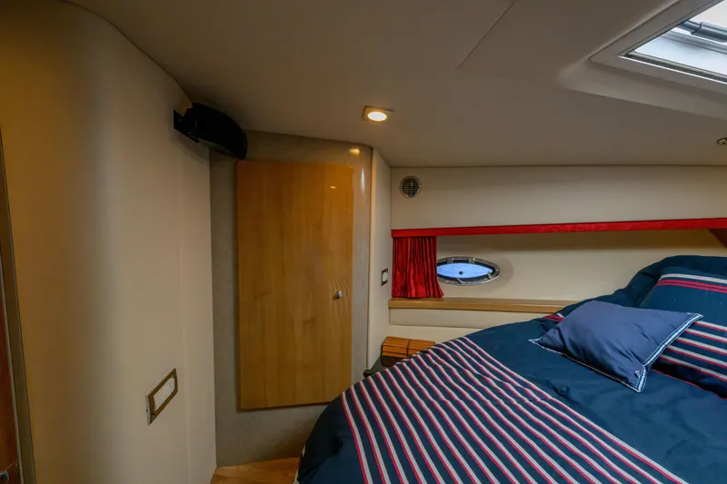 Slide: The Image of Interior cabin of 2010 Formula 45 Yacht with striped bedding and porthole window. - 32