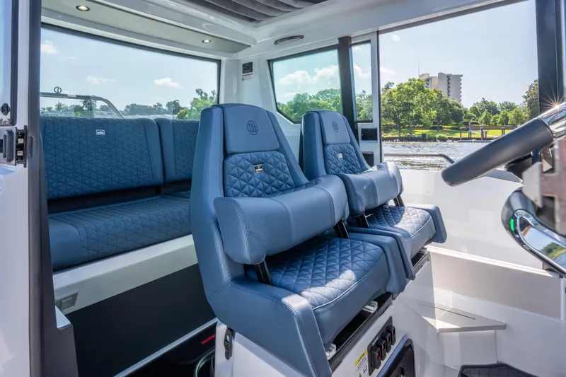 Slide: The Image of 2024 BRABUS Shadow 500 Cabin Wet Bar interior with luxurious blue seating. - 14