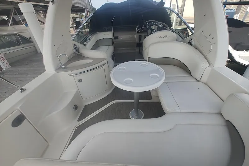 Slide: The Image of 2006 Sea Ray Sundancer 260 interior with white seating and round table. - 13
