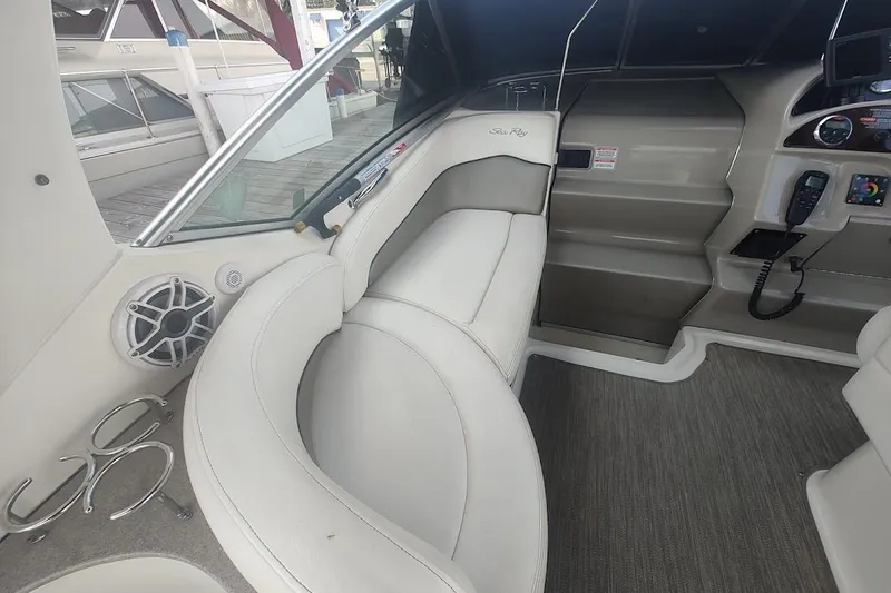 Slide: The Image of Interior of a 2006 Sea Ray Sundancer 260 boat with white seating and control panel. - 15