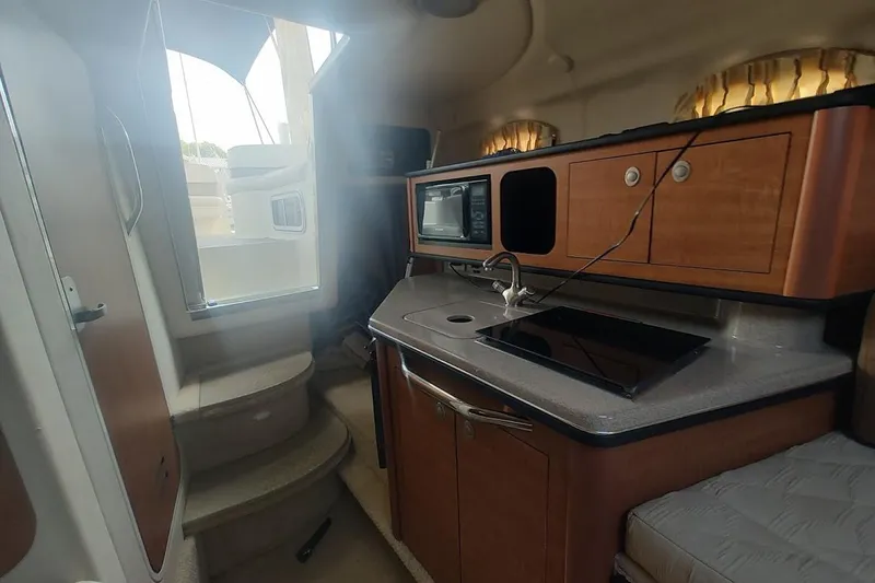 Slide: The Image of Interior of 2006 Sea Ray Sundancer 260 boat with kitchenette and stairs. - 18