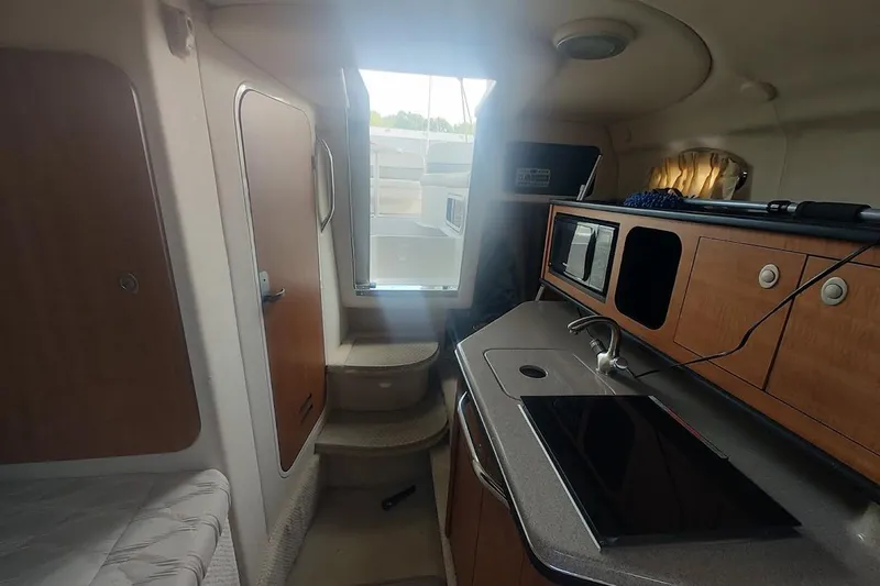 Slide: The Image of Interior of 2006 Sea Ray Sundancer 260 boat with kitchenette and stairs. - 20