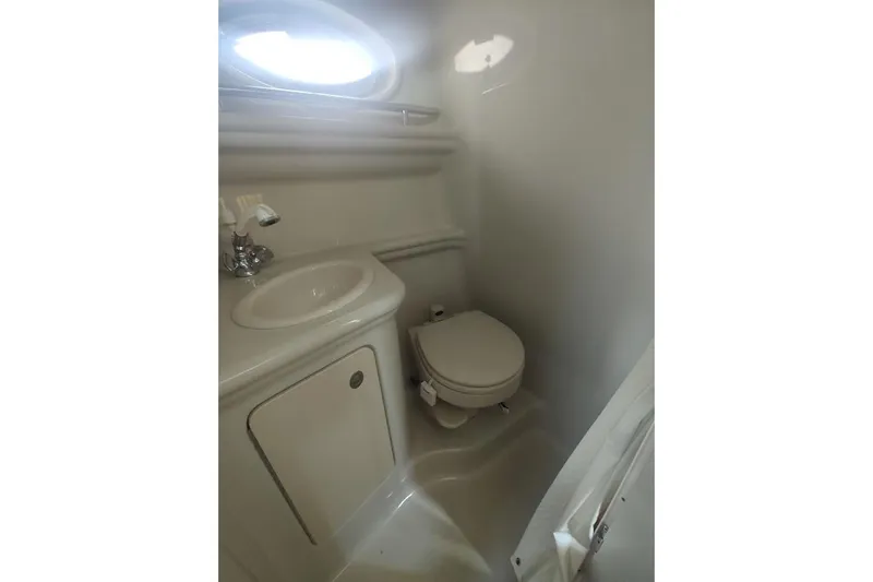 Slide: The Image of Compact bathroom in 2006 Sea Ray Sundancer 260 boat, featuring sink and toilet. - 21