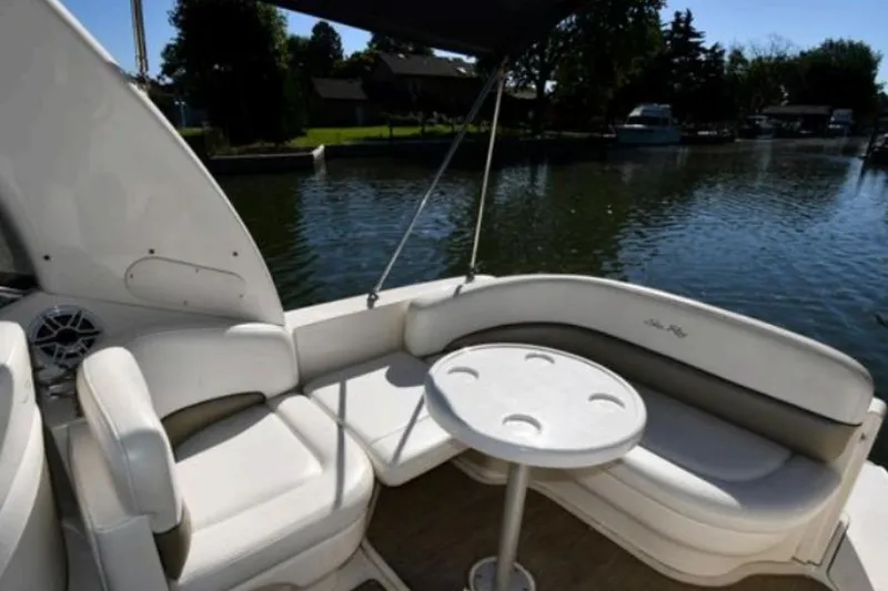 Slide: The Image of 2006 Sea Ray Sundancer 260 boat interior with seating and table by the water. - 4