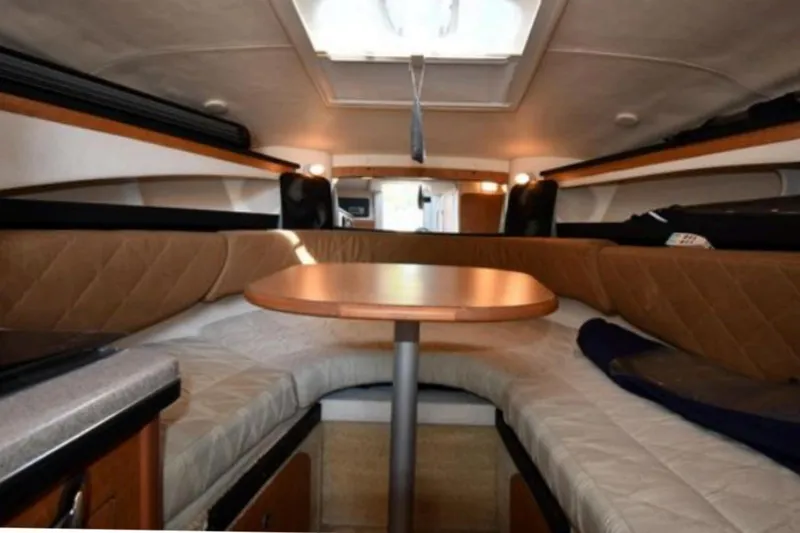 Slide: The Image of Interior of 2006 Sea Ray Sundancer 260 boat with cozy seating and table. - 8