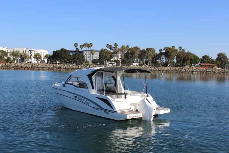 Slide: The Image of 2021 Beneteau Antares 8 boat on calm water near a scenic shoreline. - 1