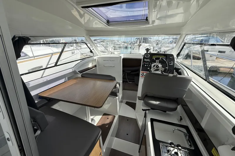 Slide: The Image of Interior of 2021 Beneteau Antares 8 boat with helm, seating, and table. - 12