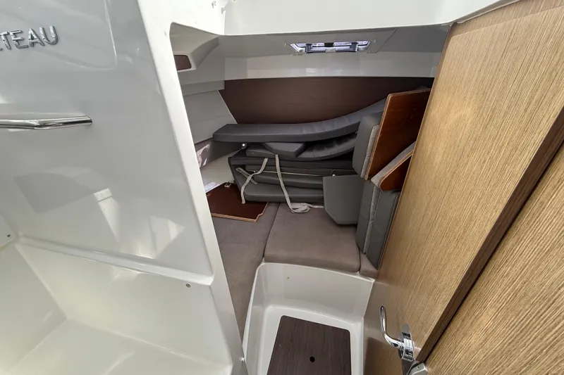 Slide: The Image of Interior cabin of 2021 Beneteau Antares 8, featuring seating and storage. - 14