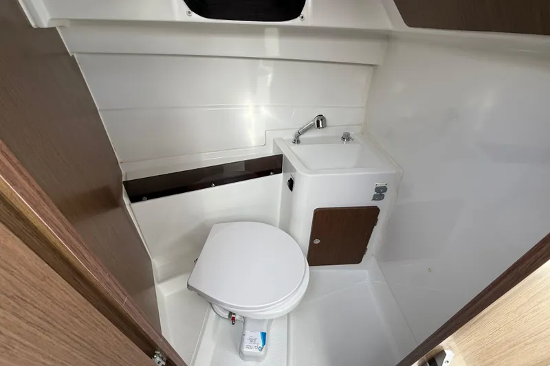 Slide: The Image of 2021 Beneteau Antares 8 boat bathroom with toilet and compact sink. - 15