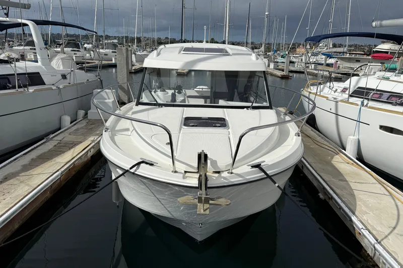 Slide: The Image of 2021 Beneteau Antares 8 docked in a marina, surrounded by other boats. - 17