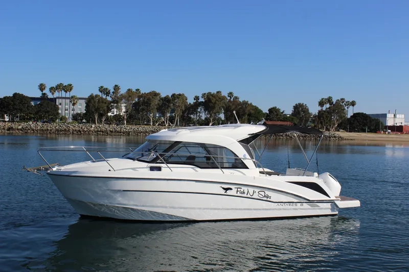 Slide: The Image of 2021 Beneteau Antares 8 boat on calm water with scenic shoreline background. - 4