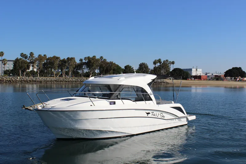Slide: The Image of 2021 Beneteau Antares 8 boat cruising on calm water with scenic background. - 6