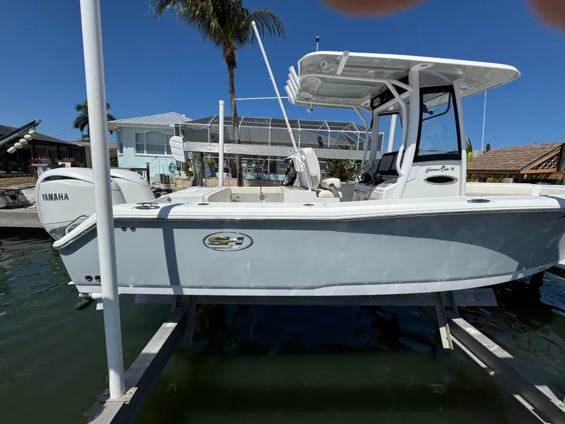 Slide: The Image of 2024 Sea Hunt Gamefish 25 boat docked, side view. - 2