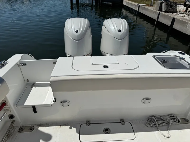Slide: The Image of 2024 Sea Hunt Gamefish 25 with twin outboard motors at dock. - 22