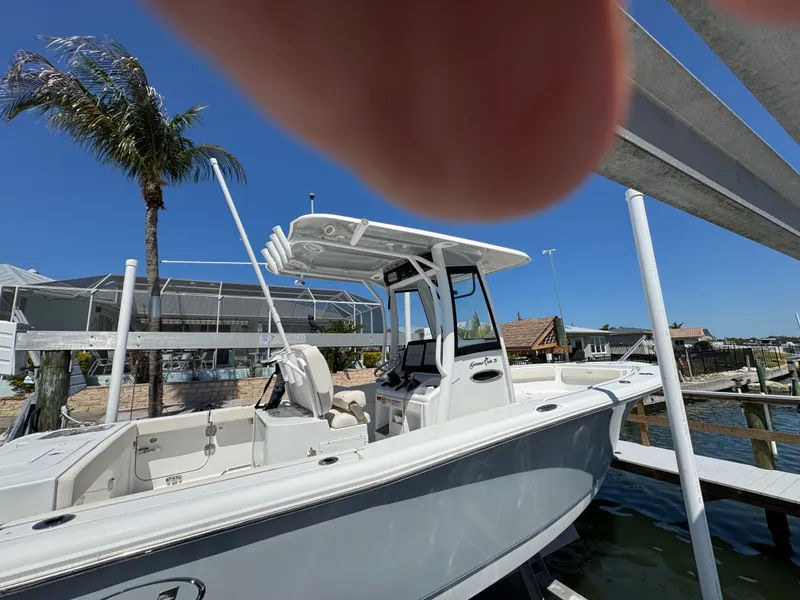 Slide: The Image of 2024 Sea Hunt Gamefish 25 boat docked under sunny skies. - 3